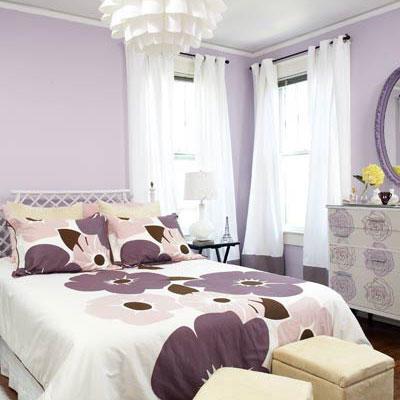 U the master bedroom, purple flowered bedspread with pale purple walls, white curtains and a white, modern chandelier