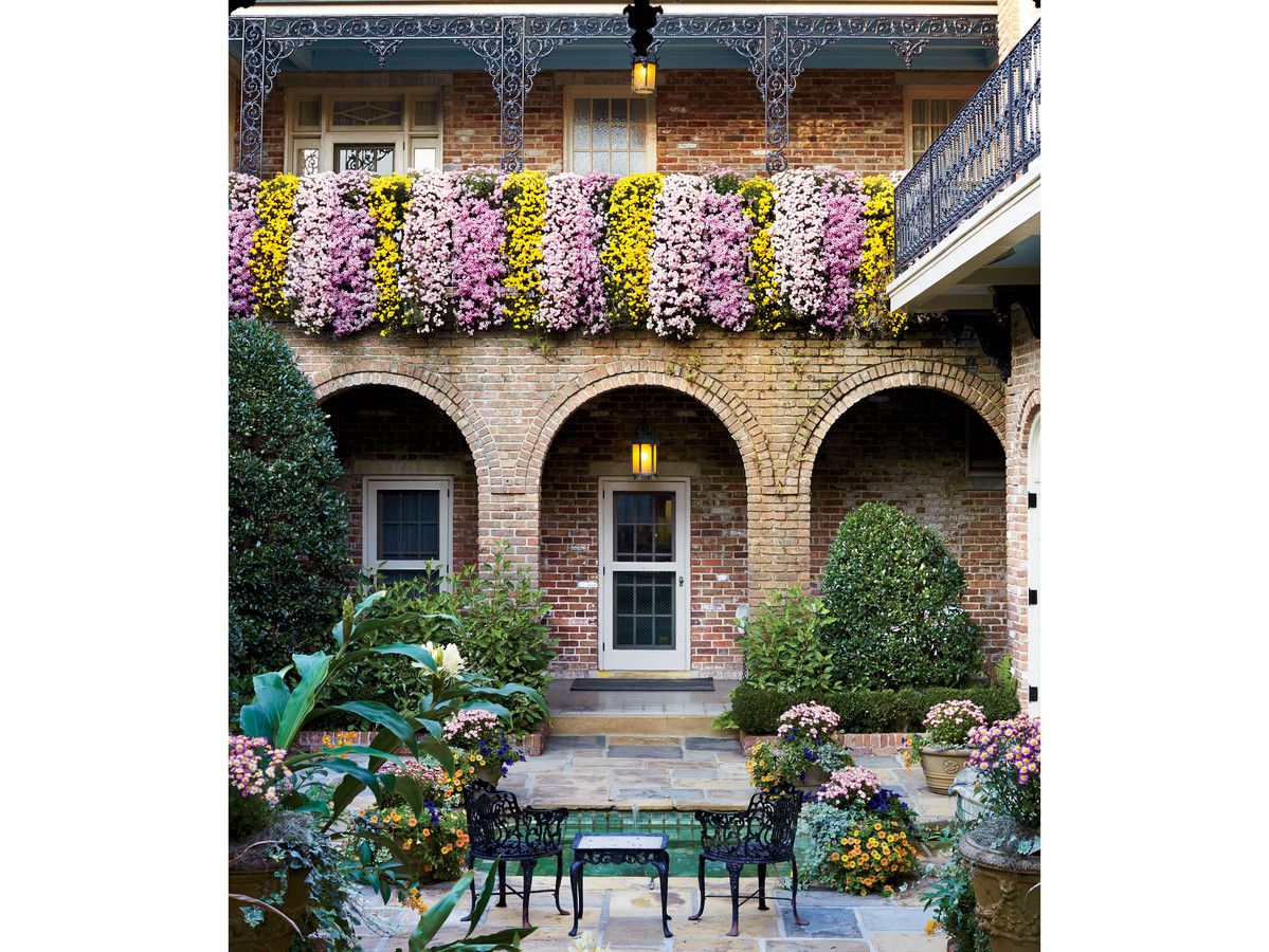 विभिन्न colors of cascade mums drape over the balcony of the historic Bellingrath Home