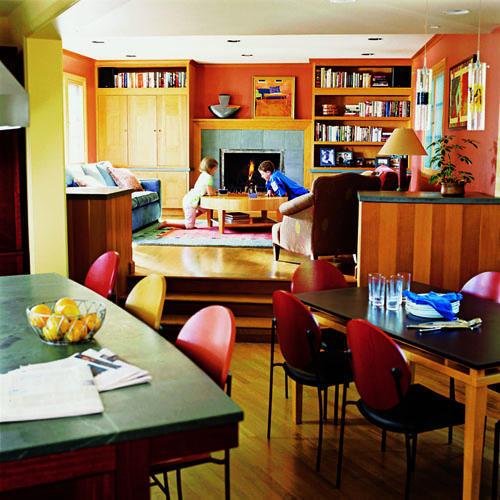 उज्ज्वल, vibrant colors and natural wood used in the kitchen area extend into the remodeled and expanded family room
