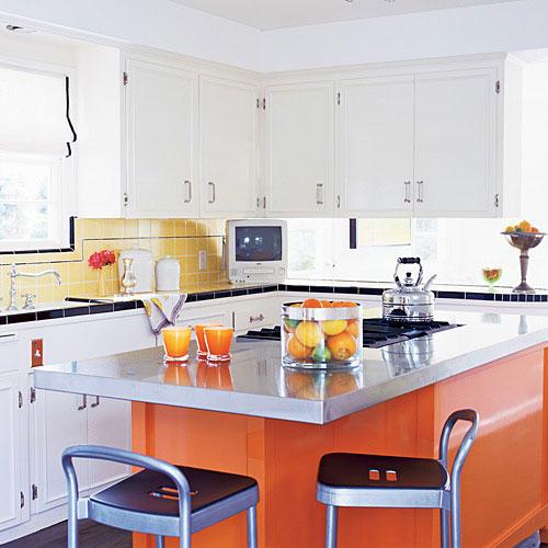  bright, orange, modern kitchen island with a steel countertop sits in the middle of this updated, vintage style kitchen