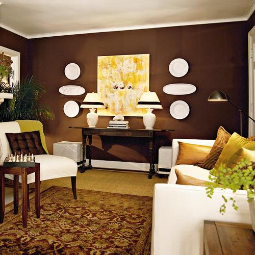 बैठक room with a white couch, brown walls, and accented in cream colors
